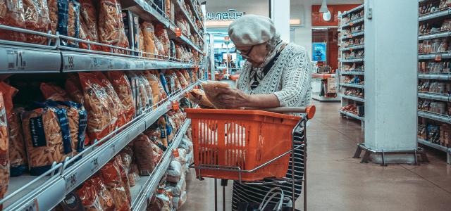 woman standing near shopping cart by Vlad Frolov courtesy of Unsplash.