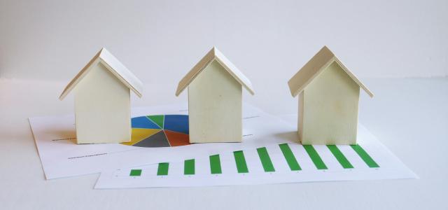 three small houses sitting on top of a piece of paper by BuyandRent Homes courtesy of Unsplash.