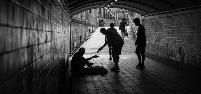 a group of people standing in a tunnel by Elyse Chia courtesy of Unsplash.